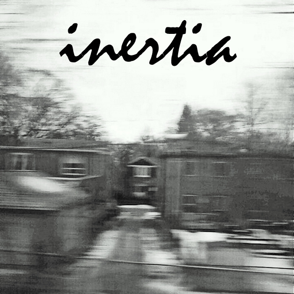 a motion-blurred picture of houses with the word Inertia overtop